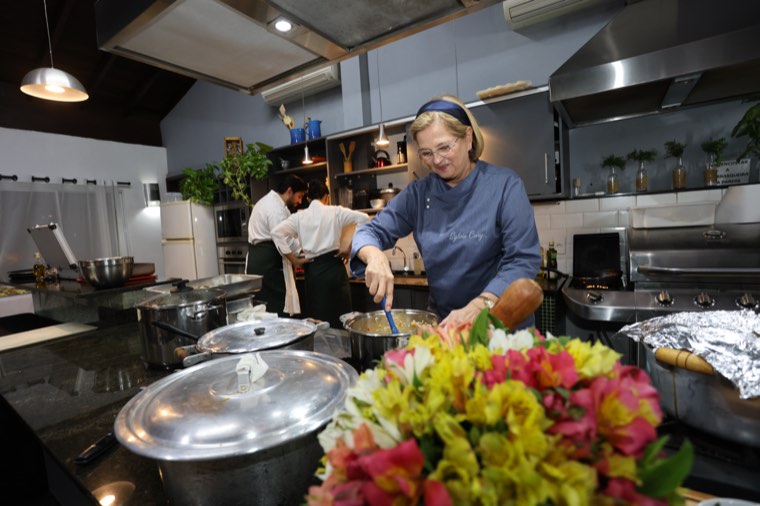 A cozinha montada para o jantar, com as panelas e um arranjo de flores